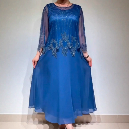 Κομψό μονόχρωμο φόρεμα με διαφανές στρώμα που λάμπει